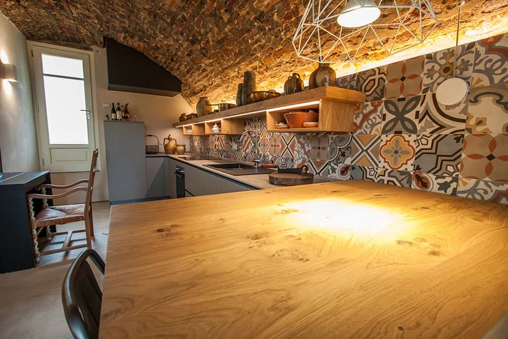 Tavolo e cucina sotto la volta — Saluzzo